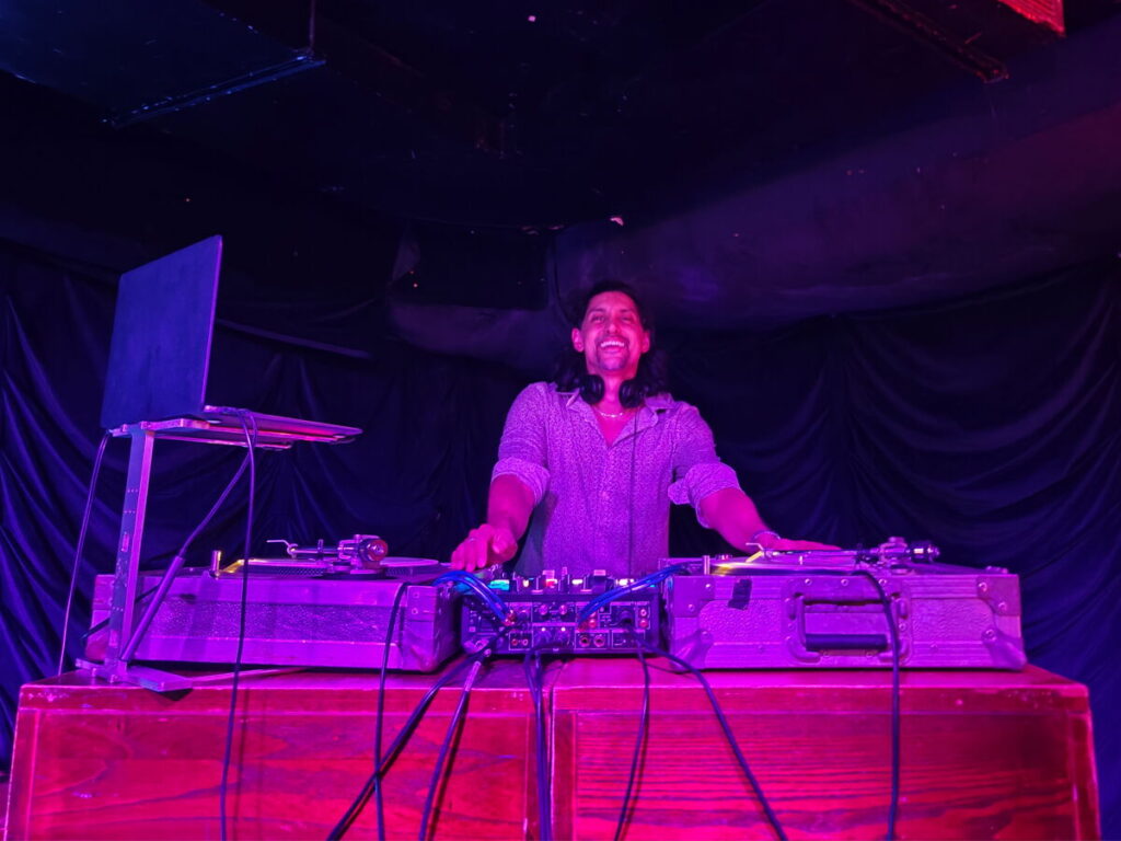 DJ SR playing vinyl on turntables at a private party