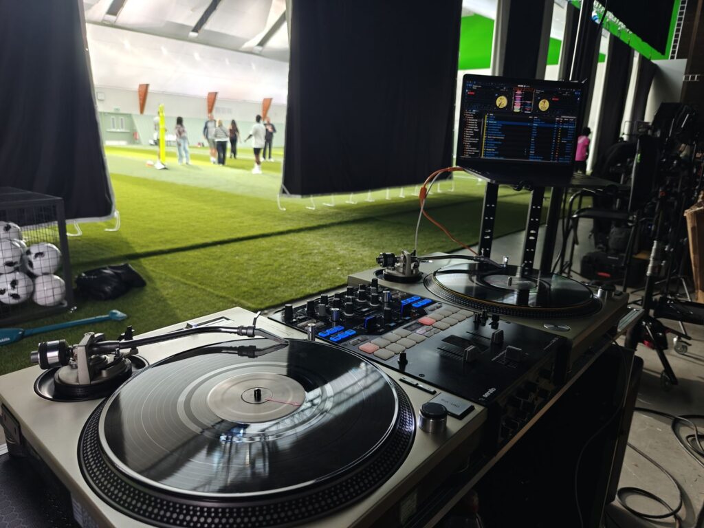 Technics turntables and a DJM mixer with a laptop on a stand at a film studio