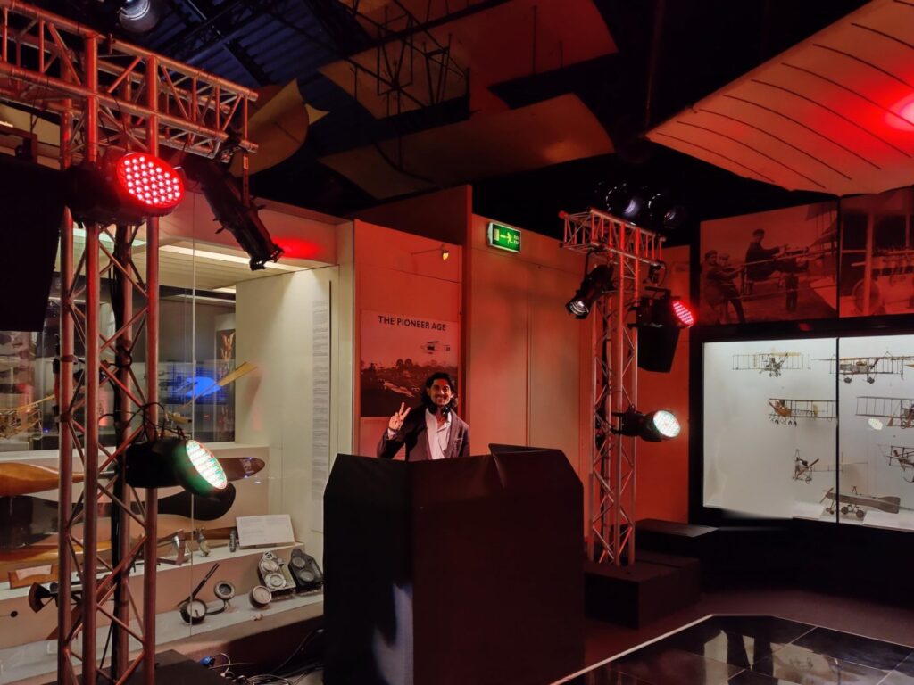 DJ SR in the DJ booth beneath an aircraft at a private event at the Science Museum, London