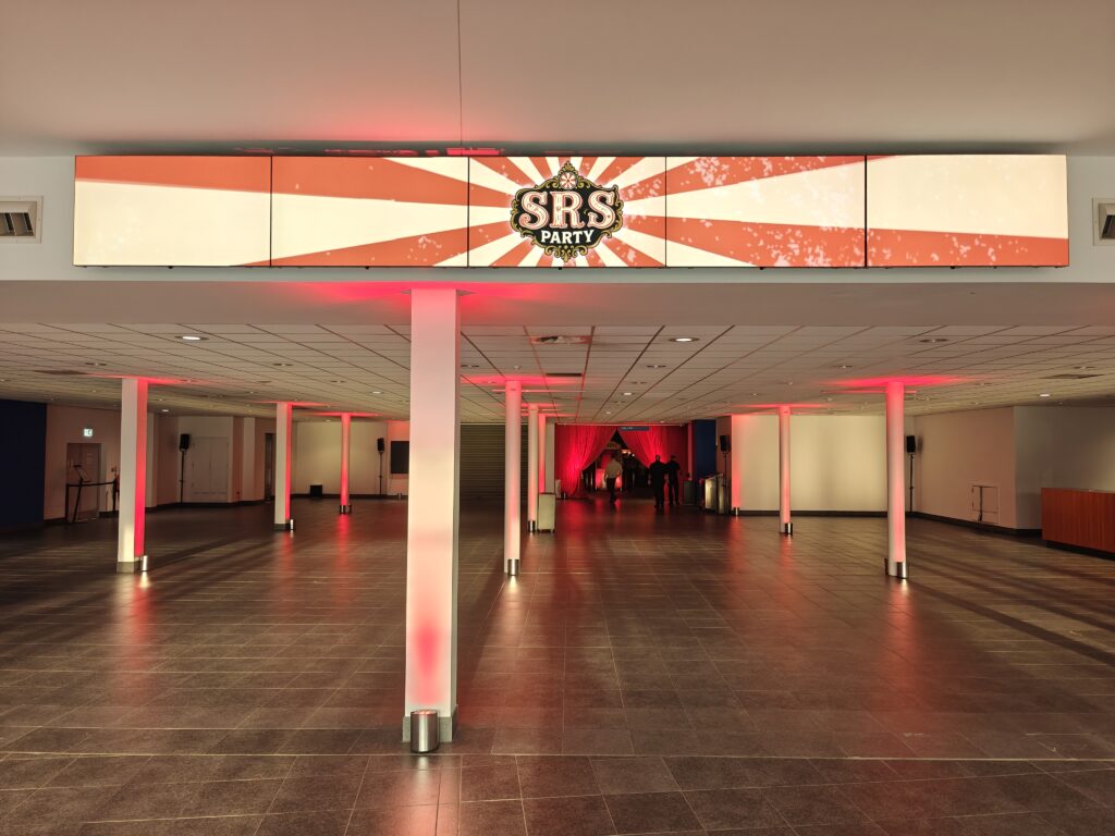 SRS Party 2025 entrance with the SRS Party logo on the video wall