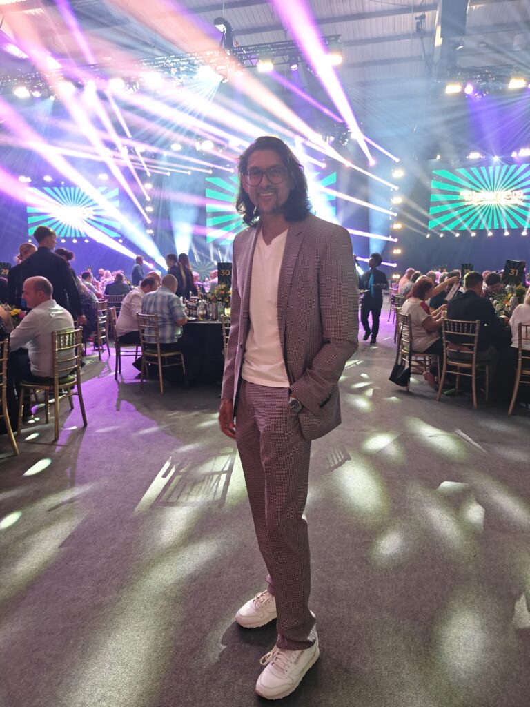 DJ SR standing in the room at the SRS gala awards night 2025, Telford International Centre
